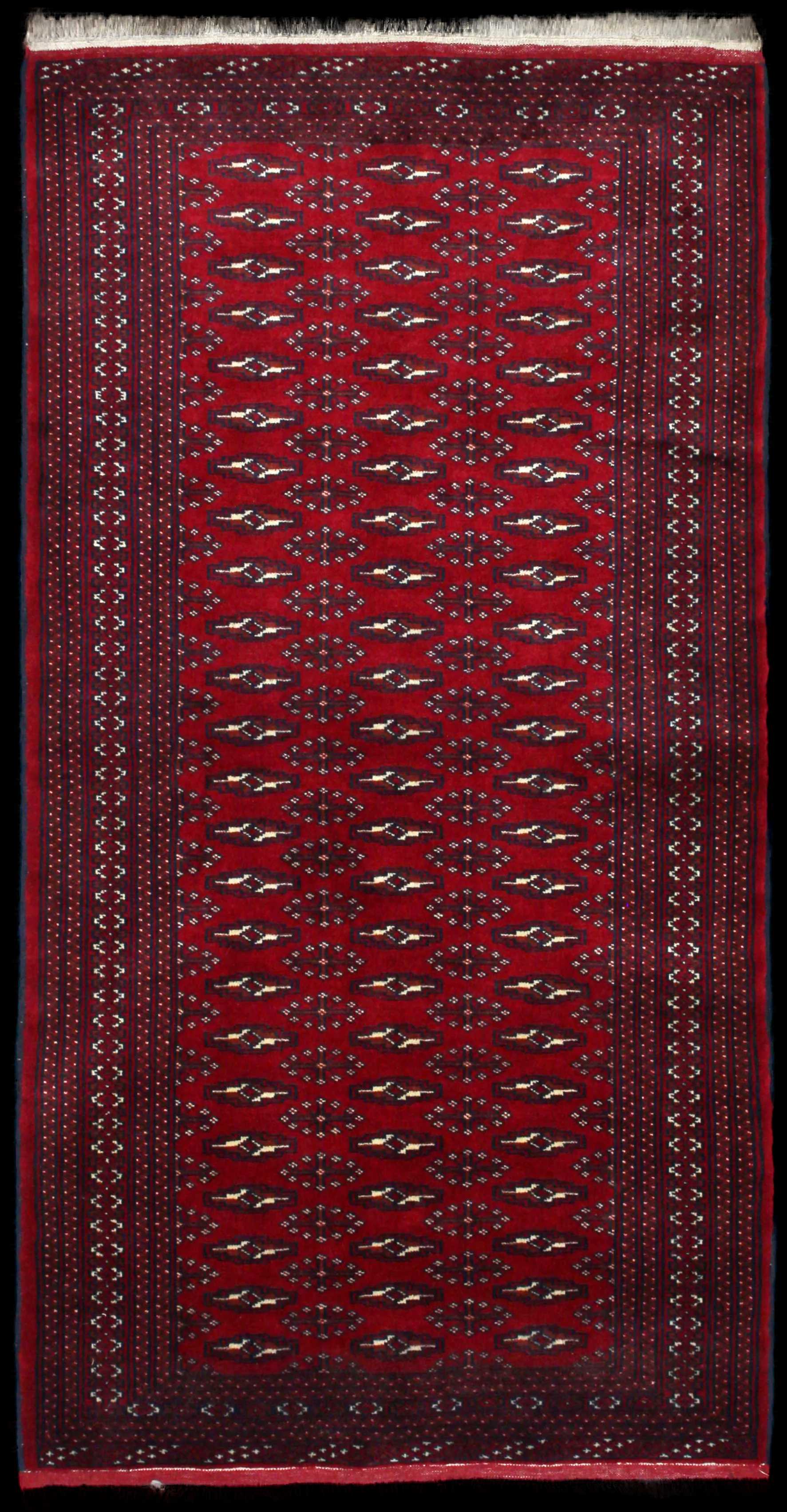 Handmade Persian rug of Turkoman style in dimensions 200 centimeters length by 102 centimetres width with mainly Red colors