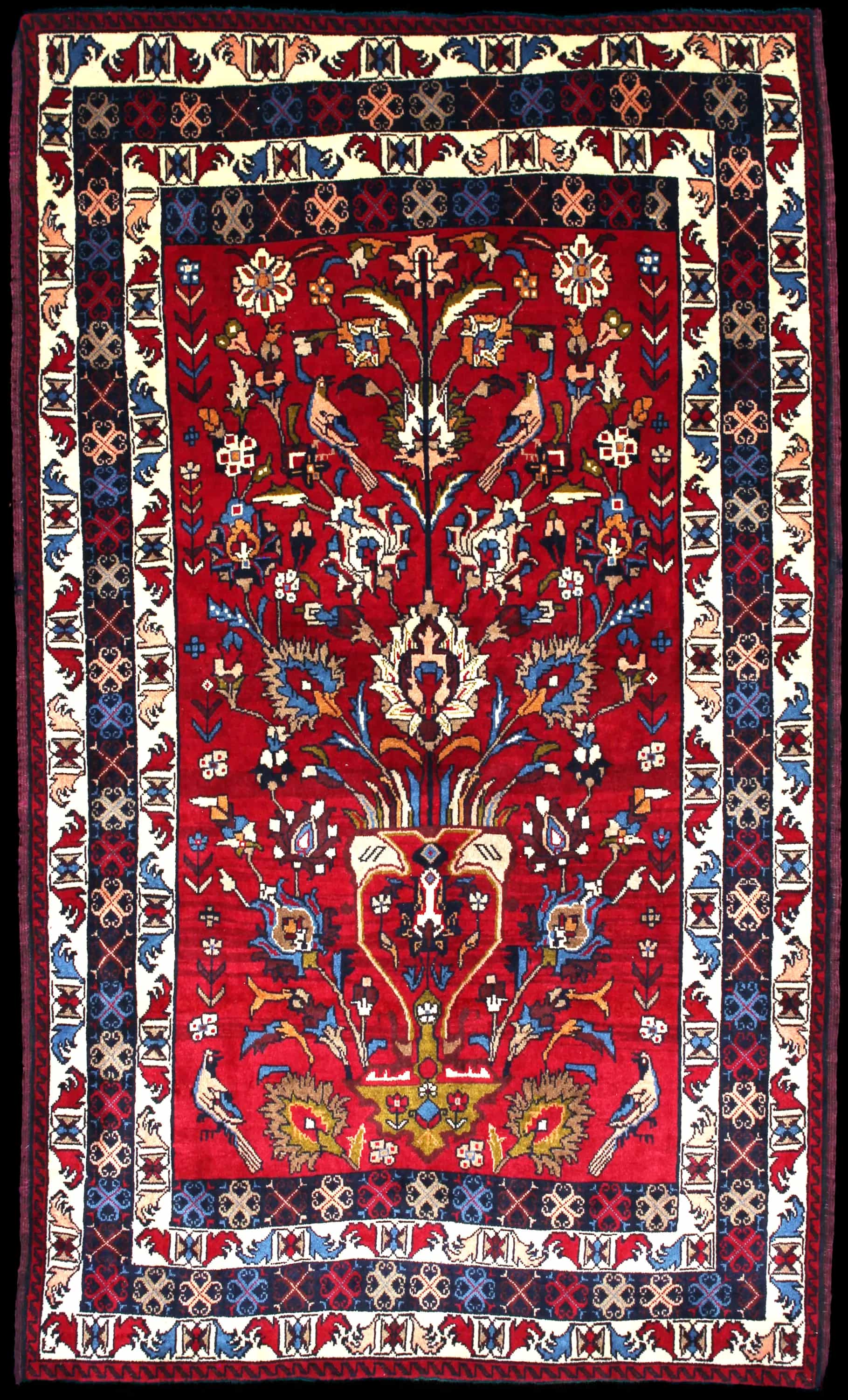 Handmade Perse rug in dimensions 220 centimeters length by 137 centimeters width with mainly Rouge et Bleu colors