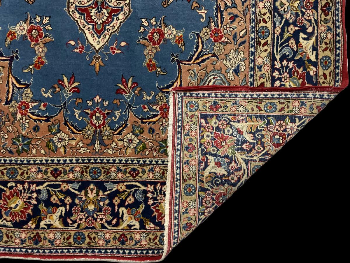 Persian rug in dimensions 220 centimeters length by 140 centimeters width with mainly blue colors — Folded