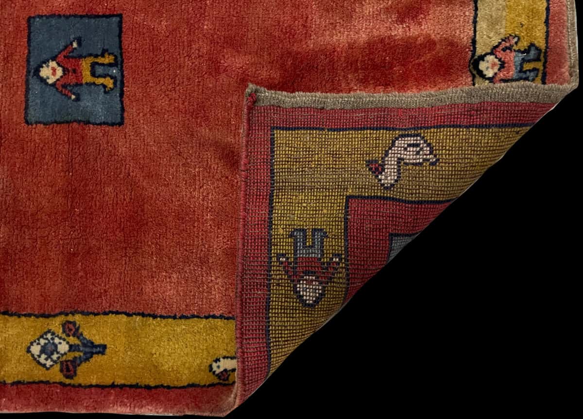 Persian rug of Gabbeh style in dimensions 155 centimeters length by 112 centimeters width with mainly red colors — Folded