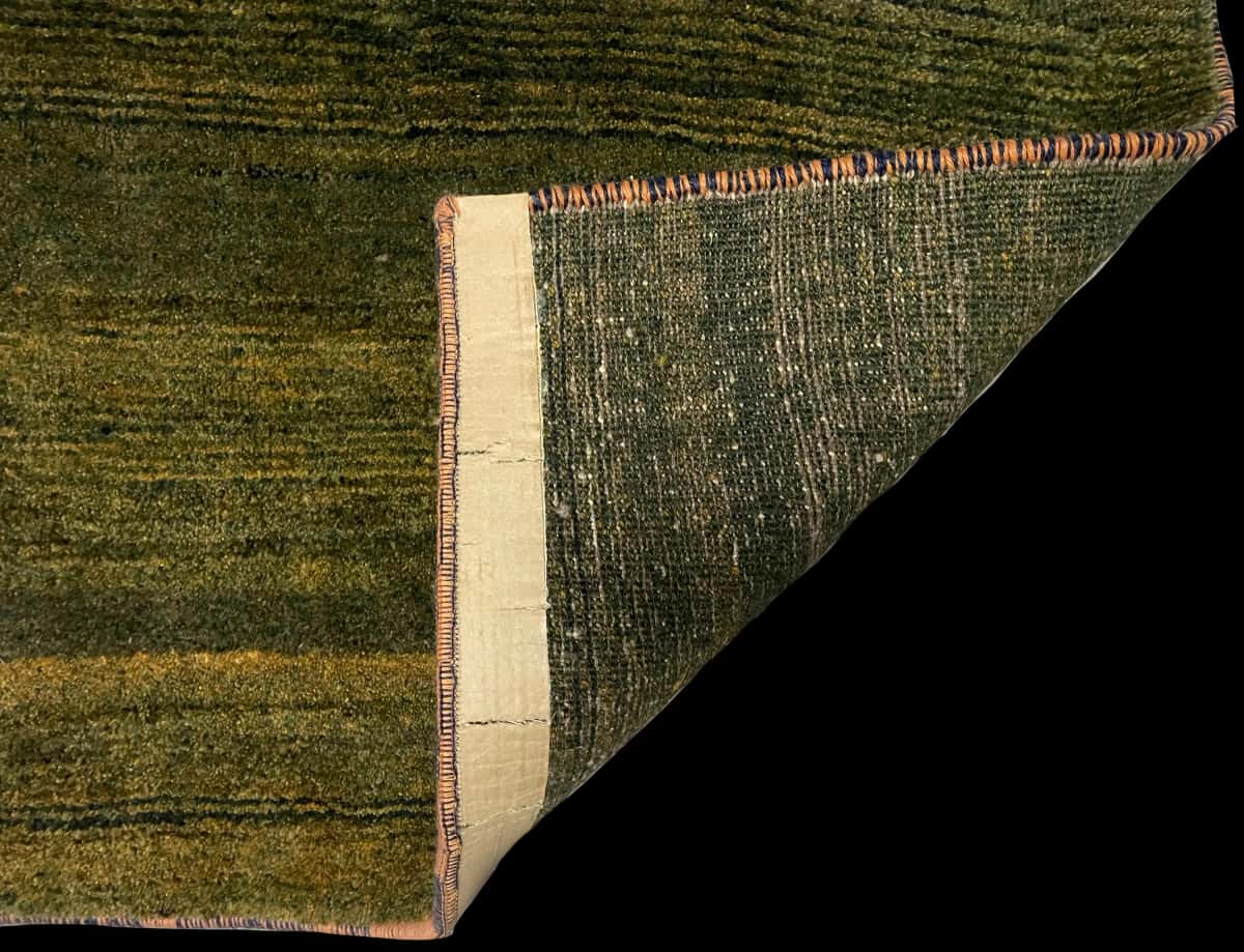 Persian rug of Gabbeh style in dimensions 165 centimeters length by 75 centimeters width with mainly green colors — Folded