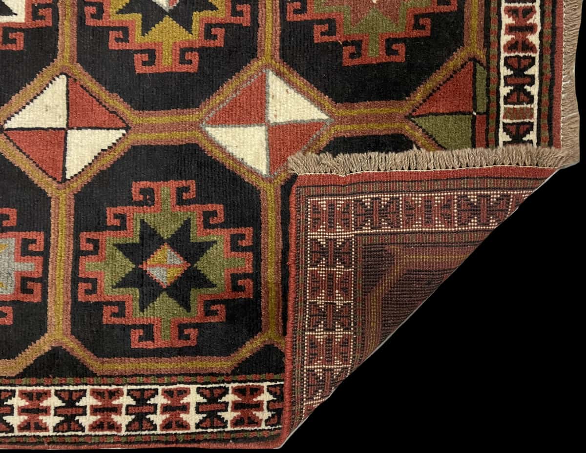 Persian rug of Quchan style in dimensions 164 centimeters length by 107 centimeters width with mainly black and brown colors — Folded