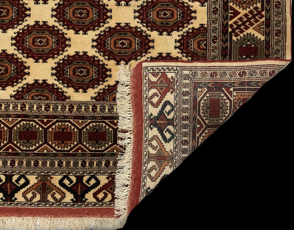 Persian rug of Turkoman style in dimensions 196 centimeters length by 140 centimeters width with mainly yellow colors — Folded