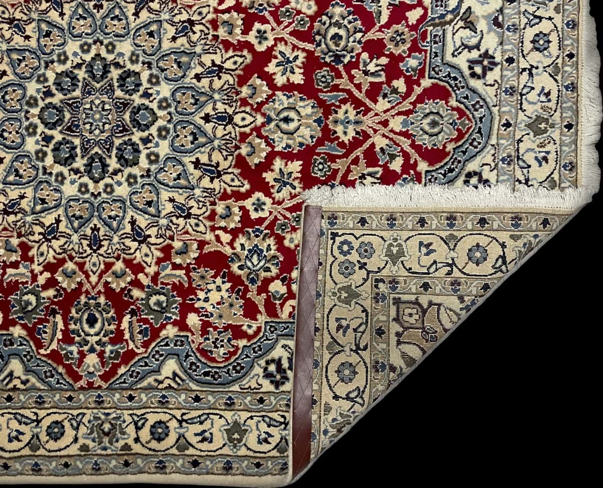 Persian rug of Nain style in dimensions 196 centimeters length by 148 centimeters width with mainly red colors — Folded