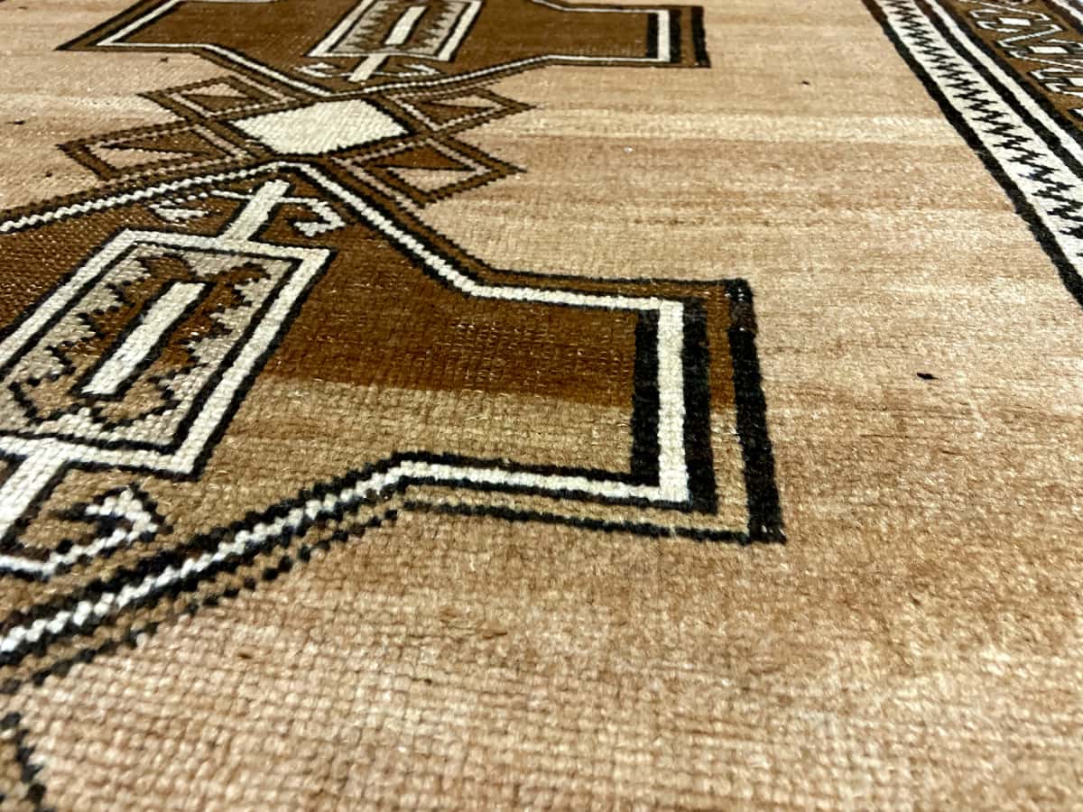 Persian rug of Baluch style in dimensions 220 centimeters length by 120 centimeters width with mainly brown colors — Texture close-up