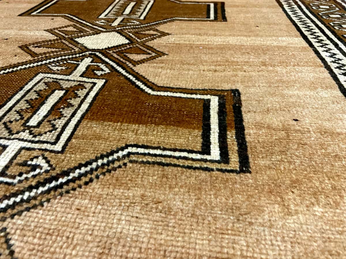 Persian rug of Baluch style in dimensions 220 centimeters length by 120 centimeters width with mainly brown colors — Texture close-up