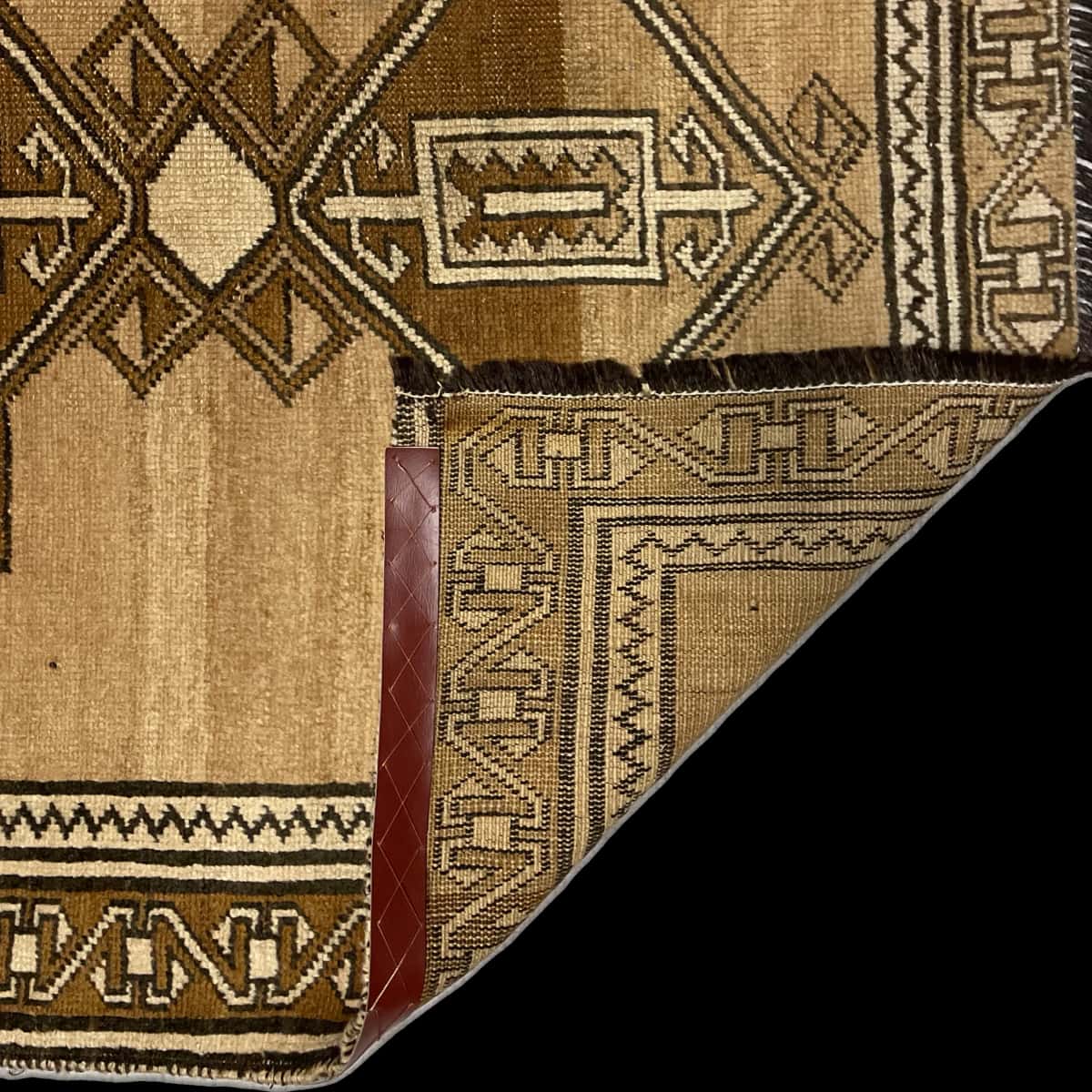 Persian rug of Baluch style in dimensions 220 centimeters length by 120 centimeters width with mainly brown colors — Folded