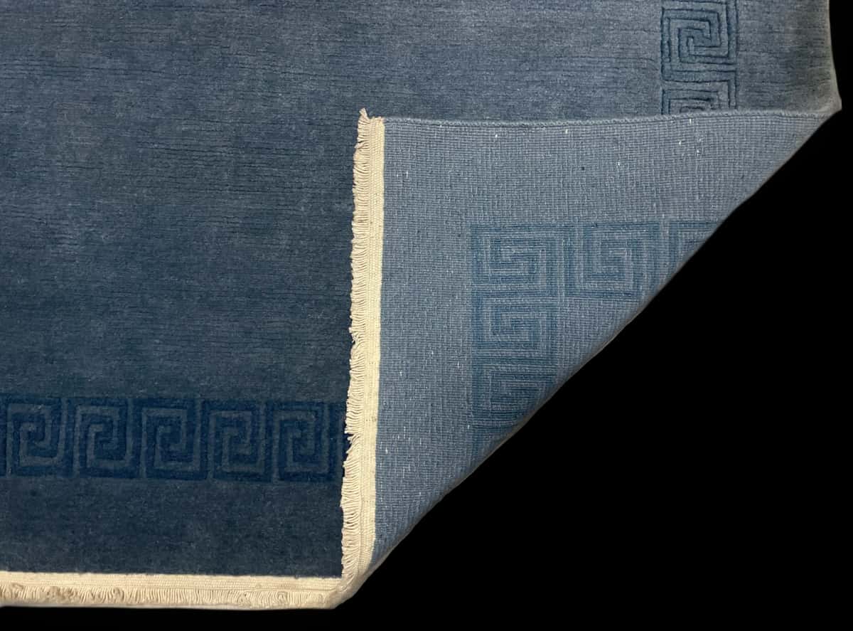 Nepali rug of Tibetan style in dimensions 203 centimeters length by 152 centimeters width with mainly blue colors — Folded