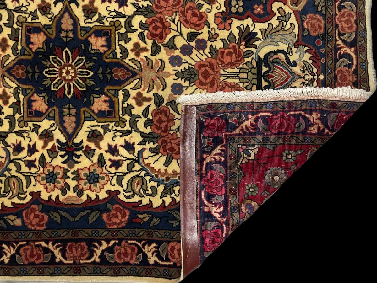 Persian rug in dimensions 141 centimeters length by 96 centimeters width with mainly yellow colors — Folded