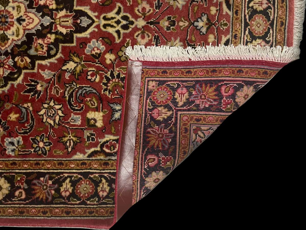 Persian rug of Ardakan style in dimensions 146 centimeters length by 105 centimeters width with mainly red colors — Folded