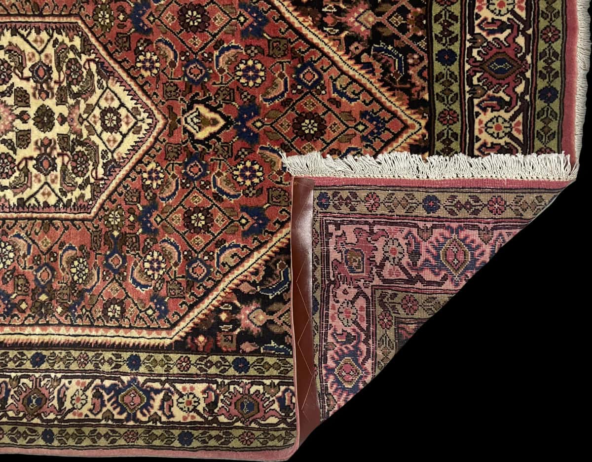 Persian rug of Bijar style in dimensions 172 centimeters length by 112 centimeters width with mainly pink colors — Folded