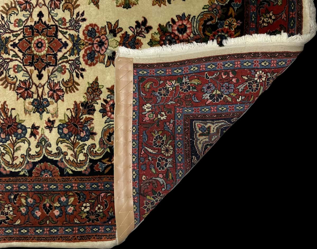 Persian rug in dimensions 145 centimeters length by 112 centimeters width with mainly beige colors — Folded