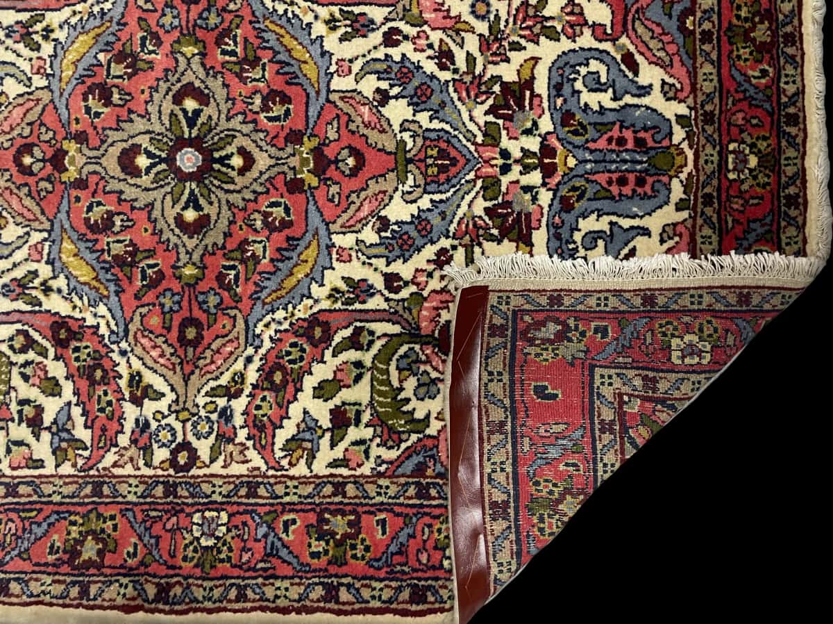 Persian rug in dimensions 140 centimeters length by 103 centimeters width with mainly red colors — Folded