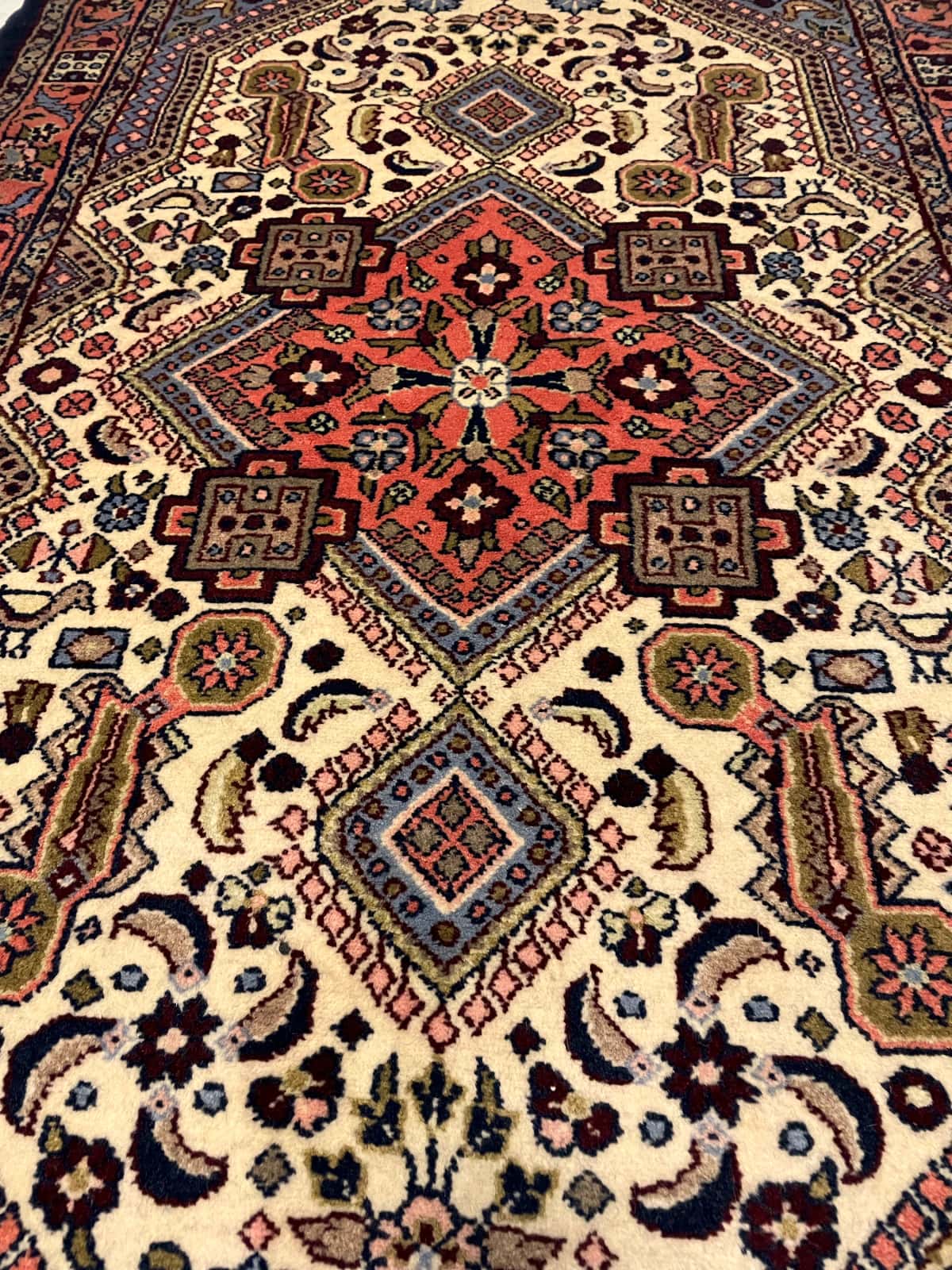 persischer Teppich im Hamadan Stil in den Maßen 148 Zentimeter Länge mal 98 Zentimeter Breite mit überwiegend beige und orange Farben — Perspektive