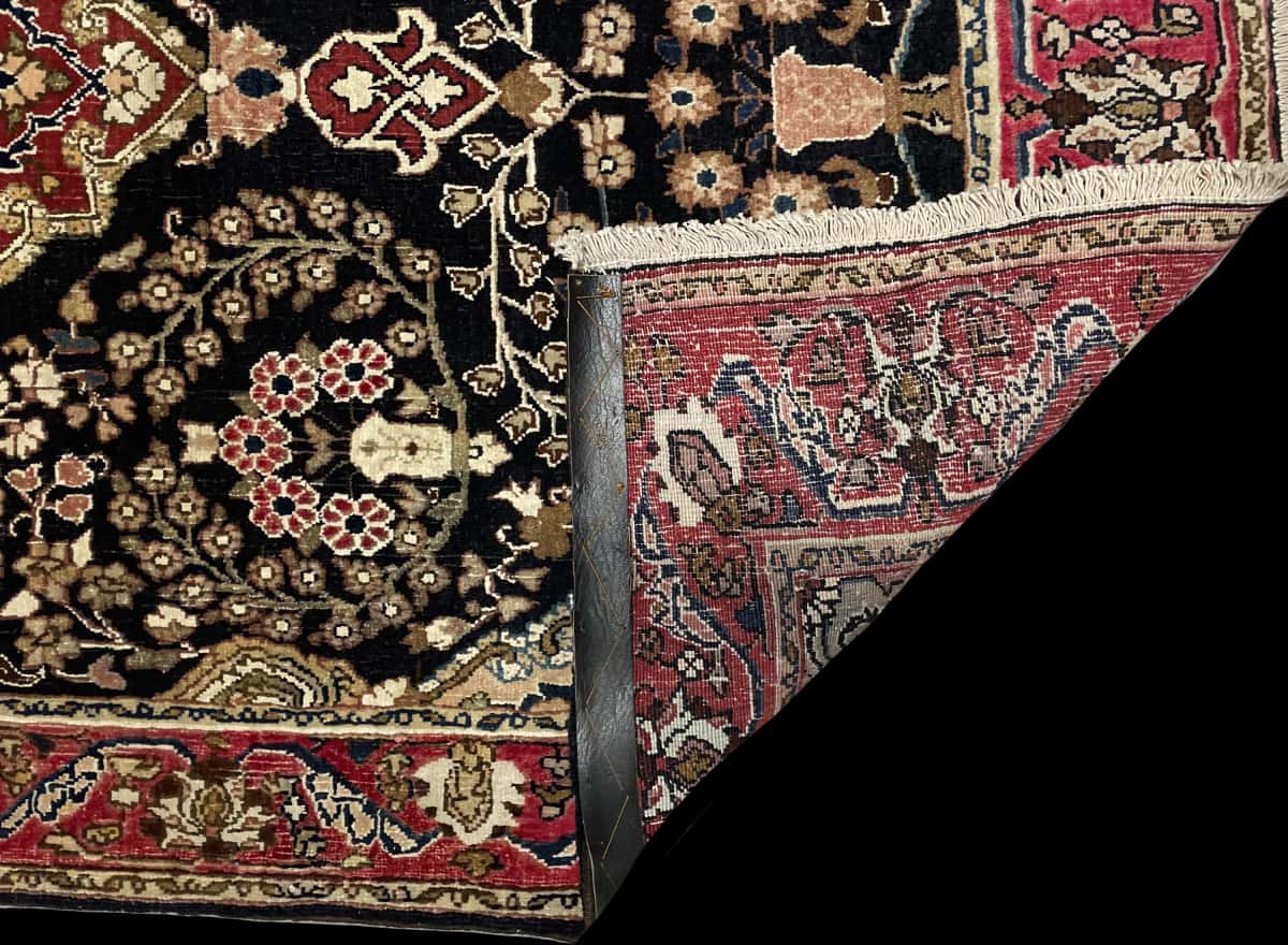Persian rug of Sanandaj style in dimensions 183 centimeters length by 112 centimeters width with mainly black colors — Folded