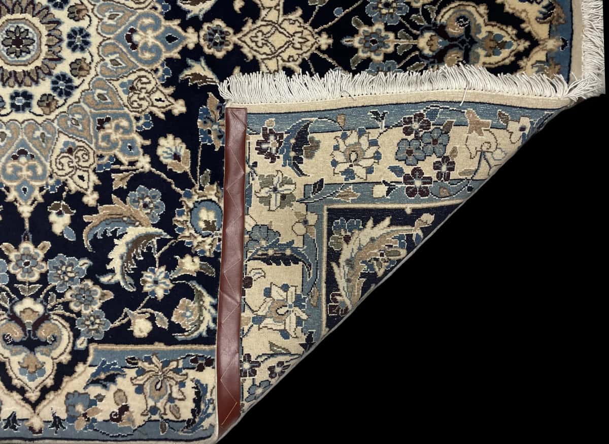 Persian rug of Nain style in dimensions 198 centimeters length by 142 centimeters width with mainly blue colors — Folded
