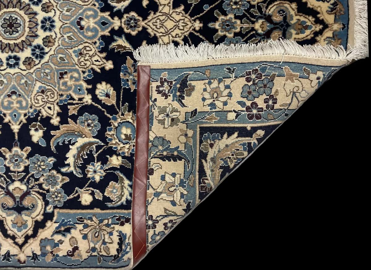 Persian rug of Nain style in dimensions 198 centimeters length by 142 centimeters width with mainly blue colors — Folded