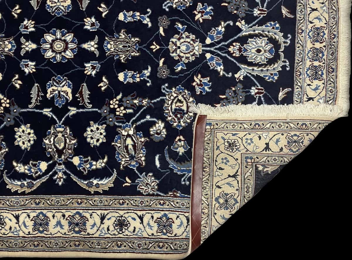 Persian rug of Nain style in dimensions 206 centimeters length by 140 centimeters width with mainly blue colors — Folded