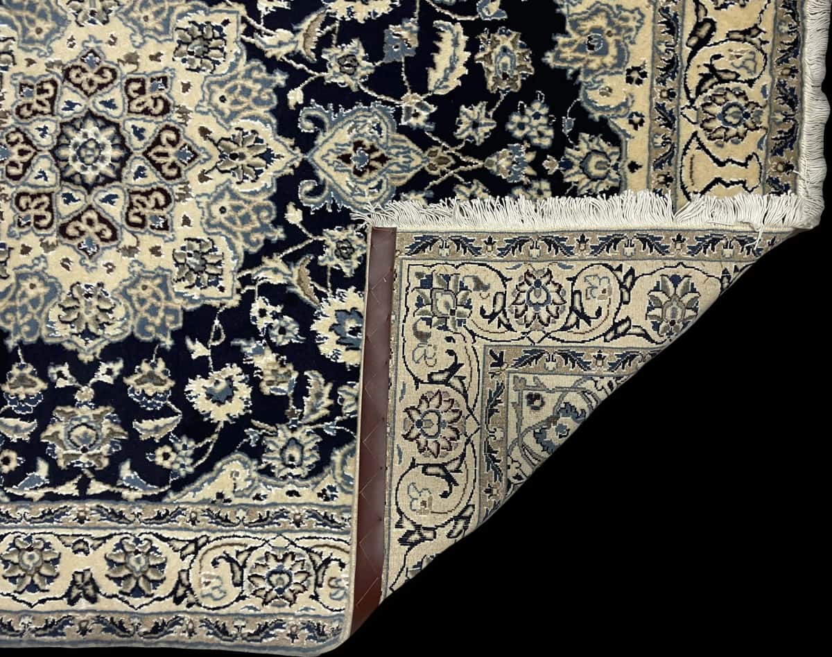 Persian rug of Nain style in dimensions 209 centimeters length by 140 centimeters width with mainly blue colors — Folded