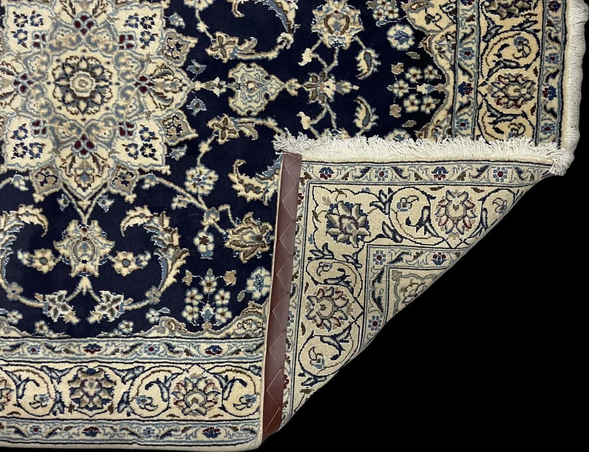 Persian rug of Nain style in dimensions 195 centimeters length by 146 centimeters width with mainly blue colors — Folded