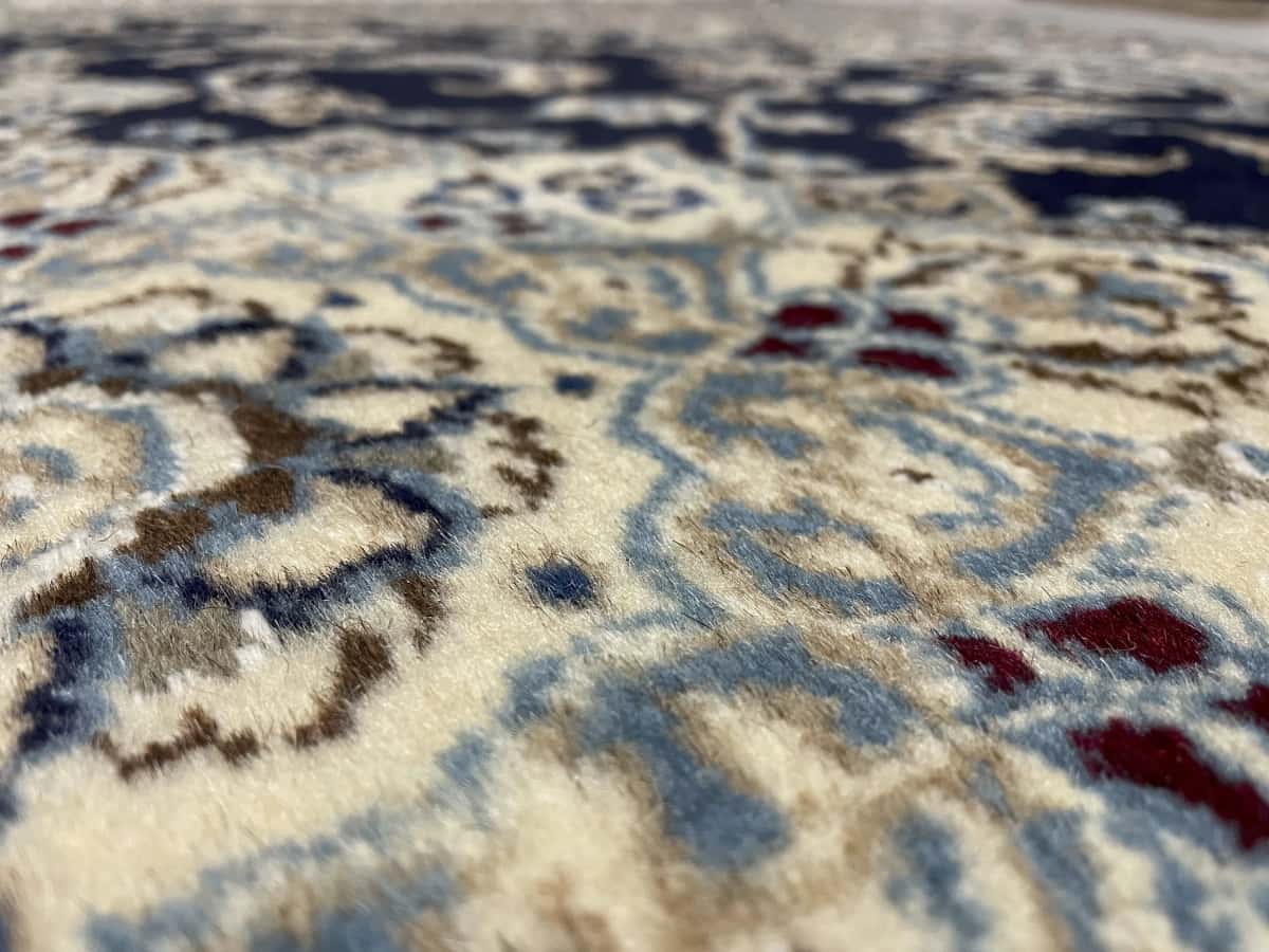 Persian rug of Nain style in dimensions 195 centimeters length by 146 centimeters width with mainly blue colors — Texture close-up