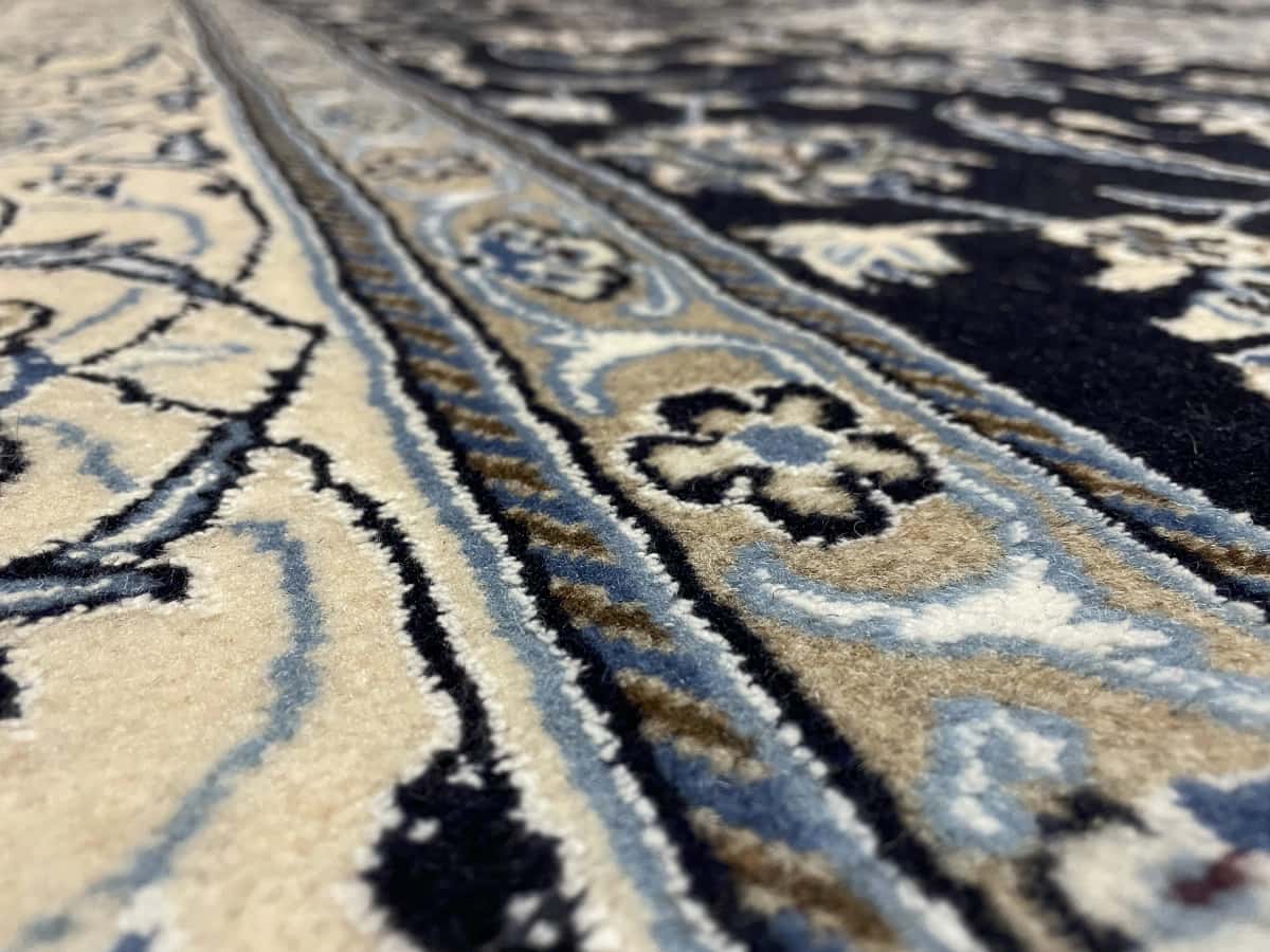 Persian rug of Nain style in dimensions 202 centimeters length by 198 centimeters width with mainly blue colors — Texture close-up