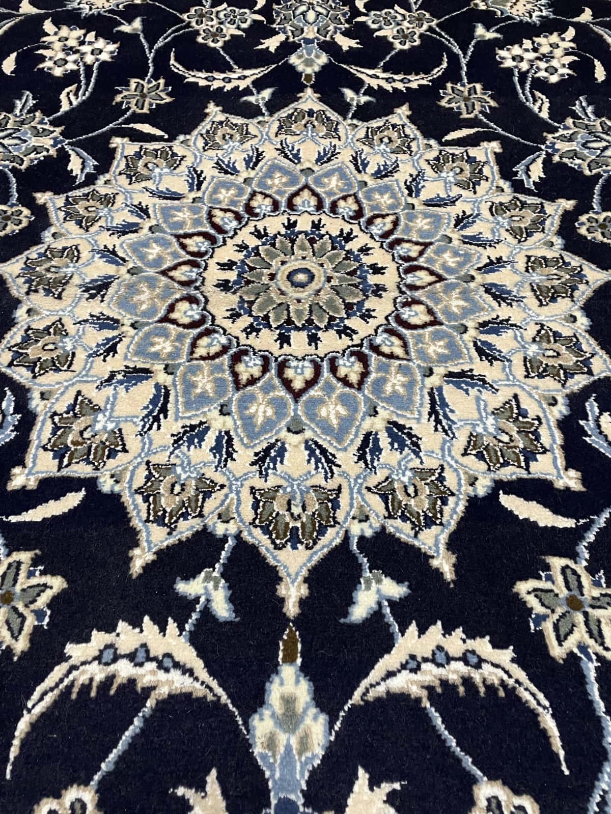 Persian rug of Nain style in dimensions 202 centimeters length by 198 centimeters width with mainly blue colors — Texture close-up