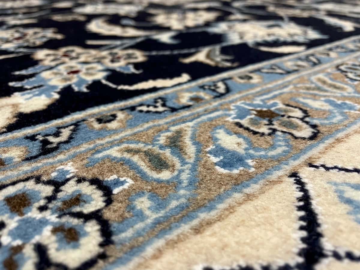 Persian rug of Nain style in dimensions 207 centimeters length by 200 centimeters width with mainly blue colors — Texture close-up