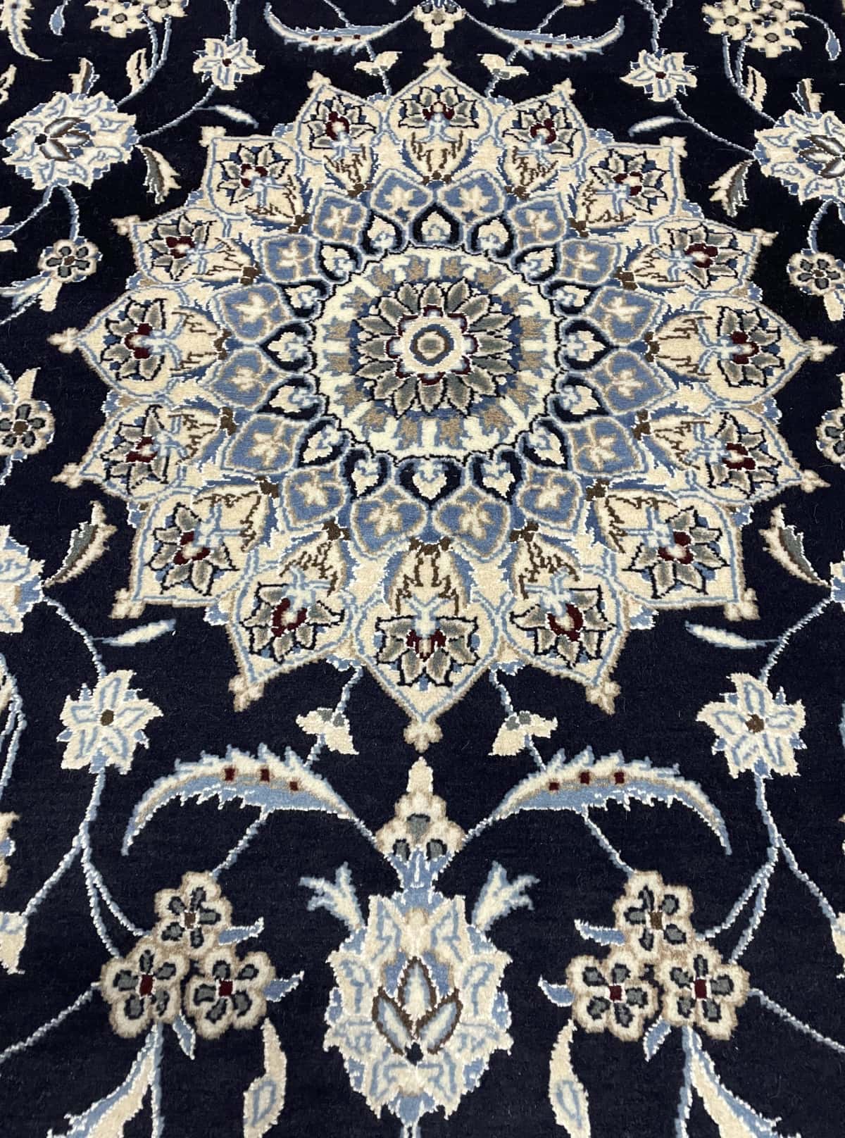 Persian rug of Nain style in dimensions 207 centimeters length by 200 centimeters width with mainly blue colors — Texture close-up