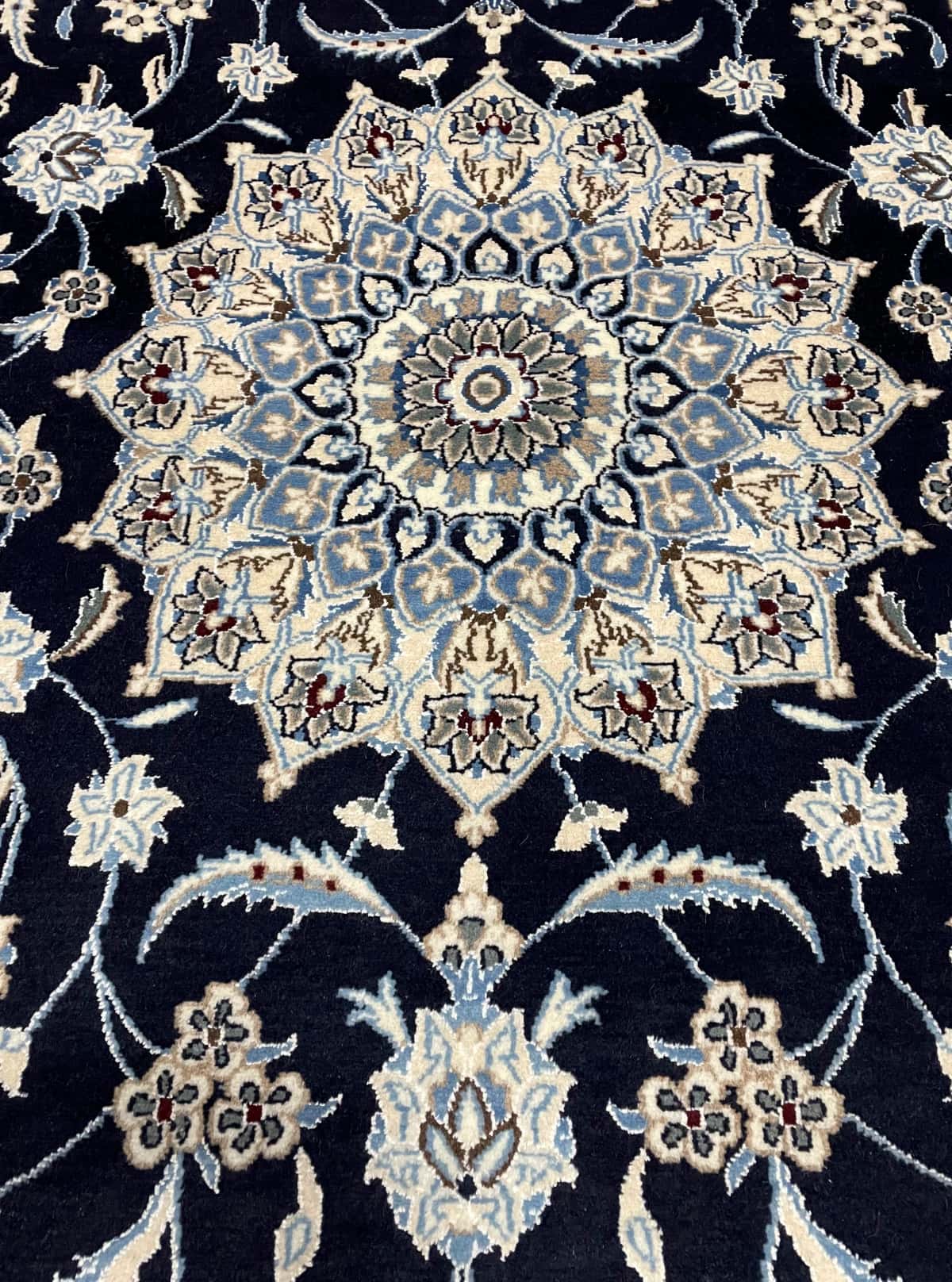 Persian rug of Nain style in dimensions 207 centimeters length by 200 centimeters width with mainly blue colors — Texture close-up