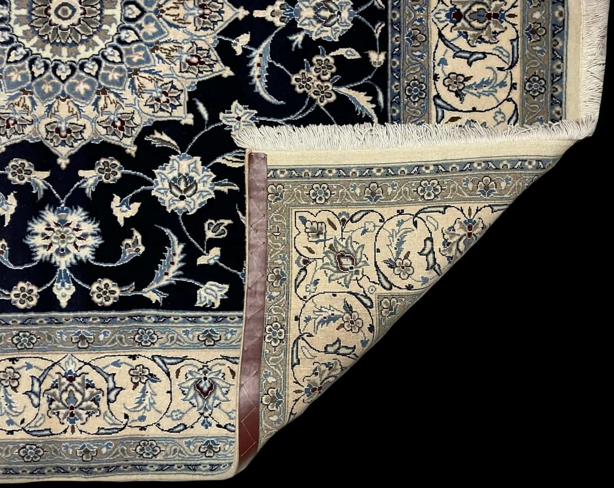 Persian rug of Nain style in dimensions 207 centimeters length by 200 centimeters width with mainly blue colors — Folded