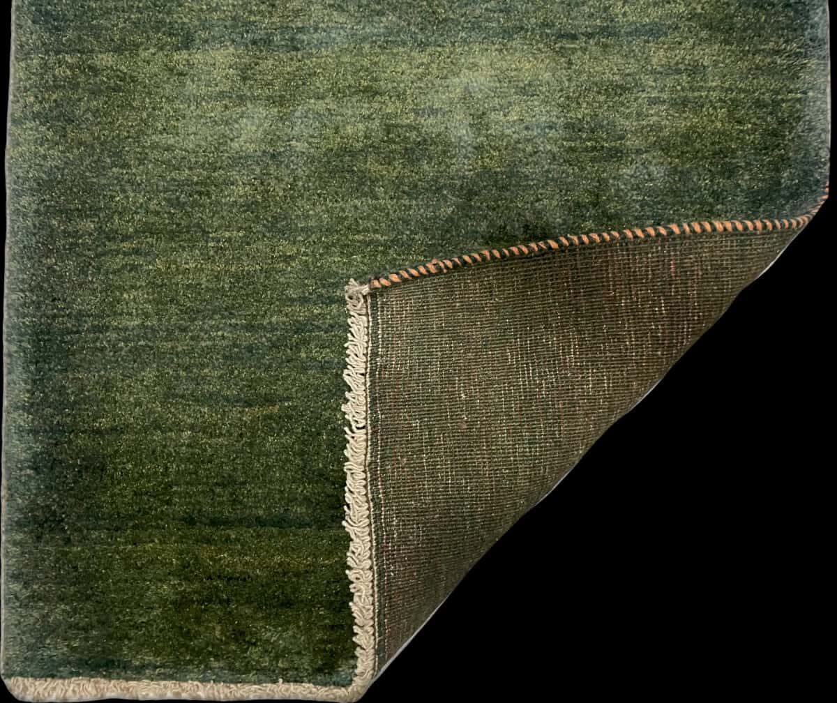 Persian rug of Gabbeh style in dimensions 122 centimeters length by 90 centimeters width with mainly green colors — Folded