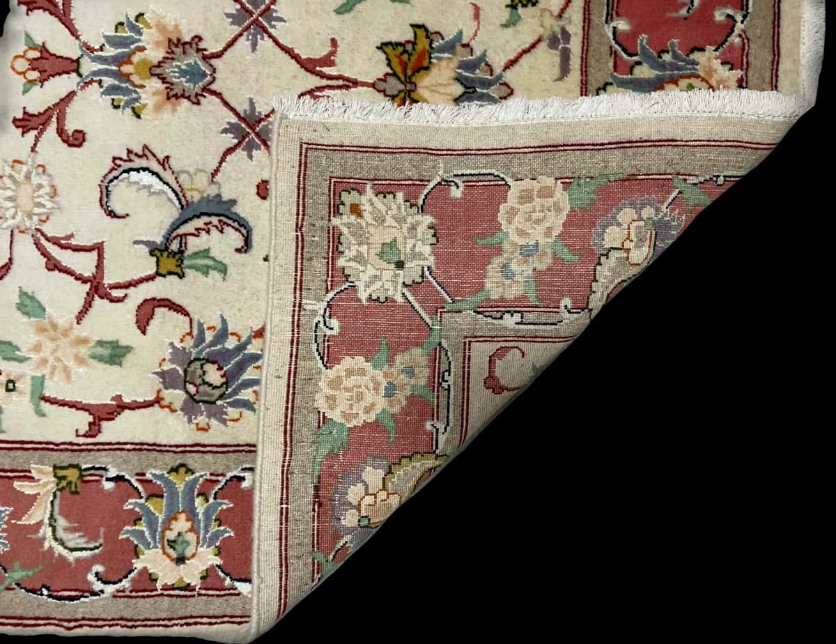 persischer Teppich im Tabriz Stil in den Maßen 195 Zentimeter Länge mal 123 Zentimeter Breite mit überwiegend beige Farben — Gefaltet