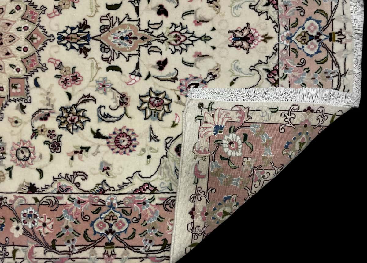 Persian rug of Tabriz style in dimensions 208 centimeters length by 134 centimeters width with mainly beige and pink colors — Folded