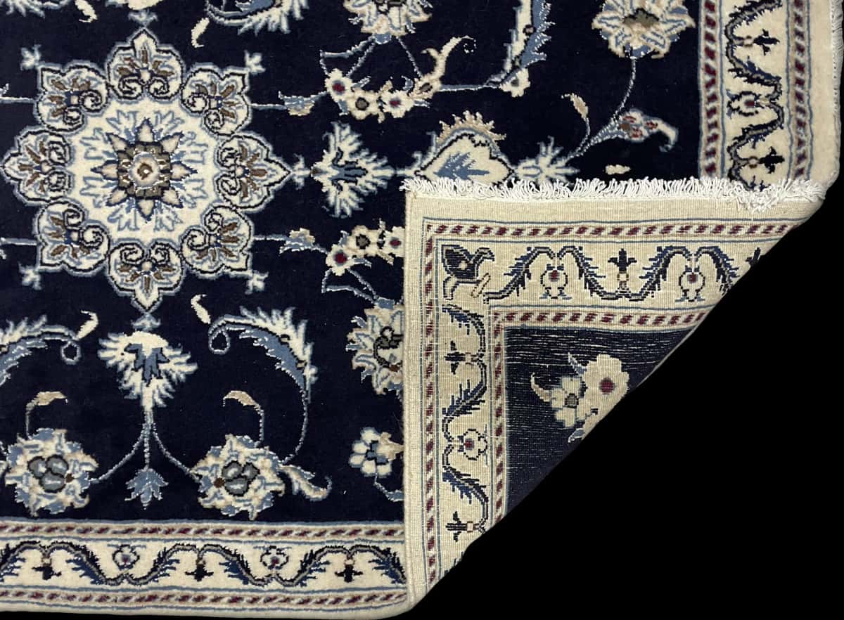 Persian rug of Nain style in dimensions 150 centimeters length by 98 centimeters width with mainly blue colors — Folded