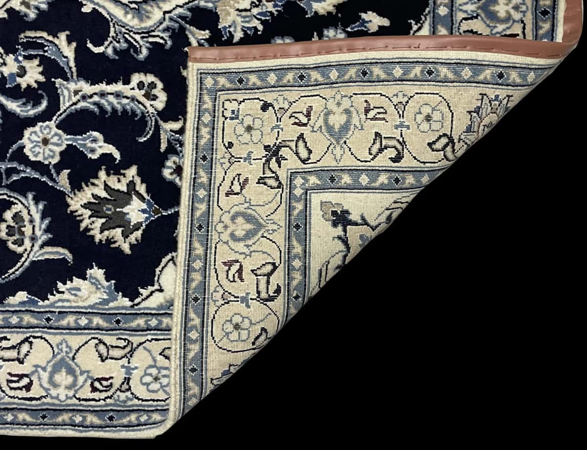 Persian rug of Nain style in dimensions 204 centimeters length by 125 centimeters width with mainly blue colors — Folded