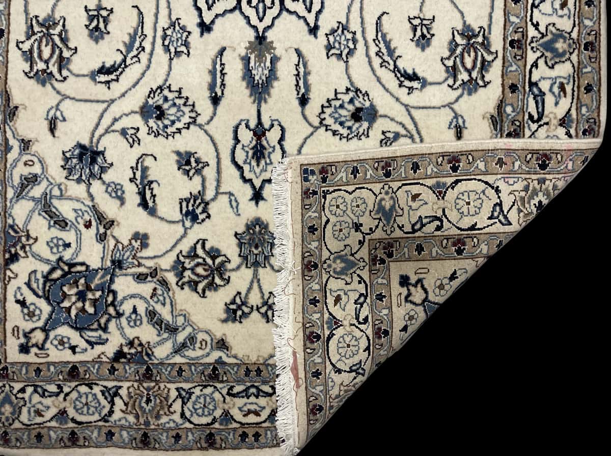 Persian rug of Nain style in dimensions 202 centimeters length by 120 centimeters width with mainly beige and blue colors — Folded
