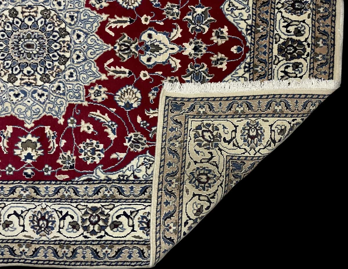 Persian rug of Nain style in dimensions 203 centimeters length by 140 centimeters width with mainly red and blue colors — Folded