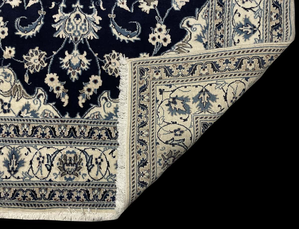 Persian rug of Nain style in dimensions 204 centimeters length by 148 centimeters width with mainly blue colors — Folded