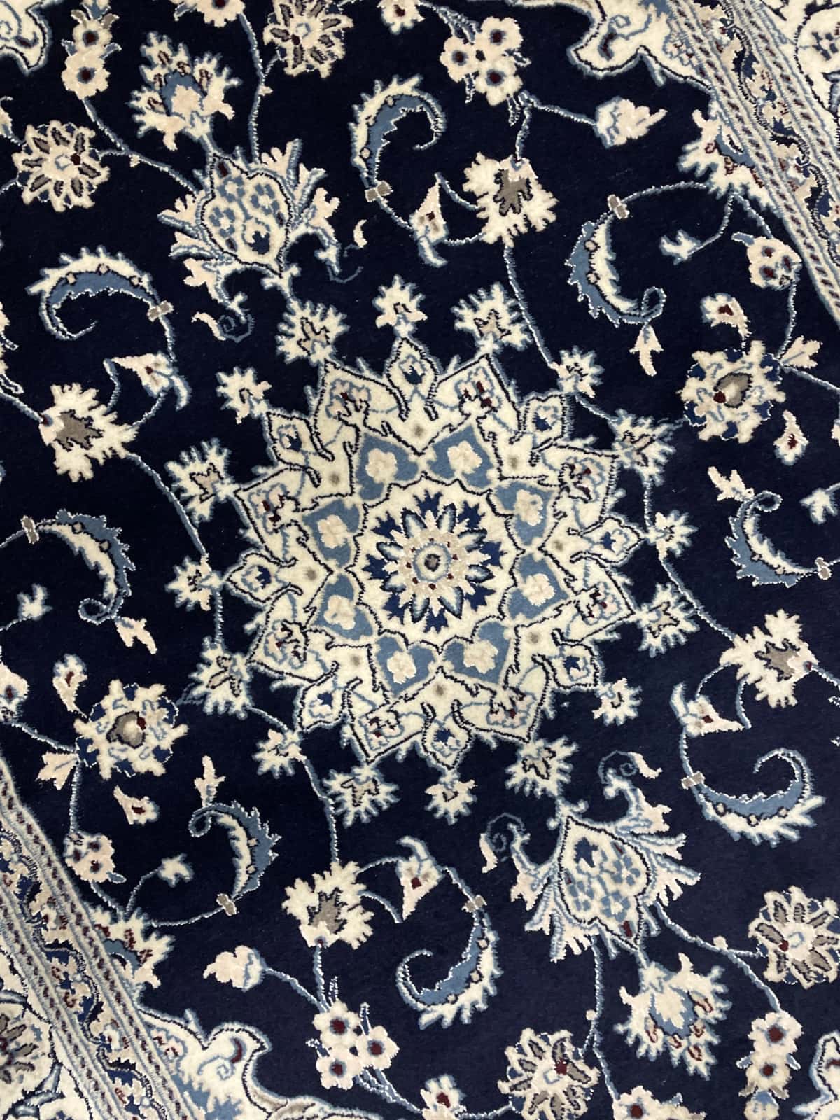 Persian rug of Nain style in dimensions 204 centimeters length by 148 centimeters width with mainly blue colors — Texture close-up