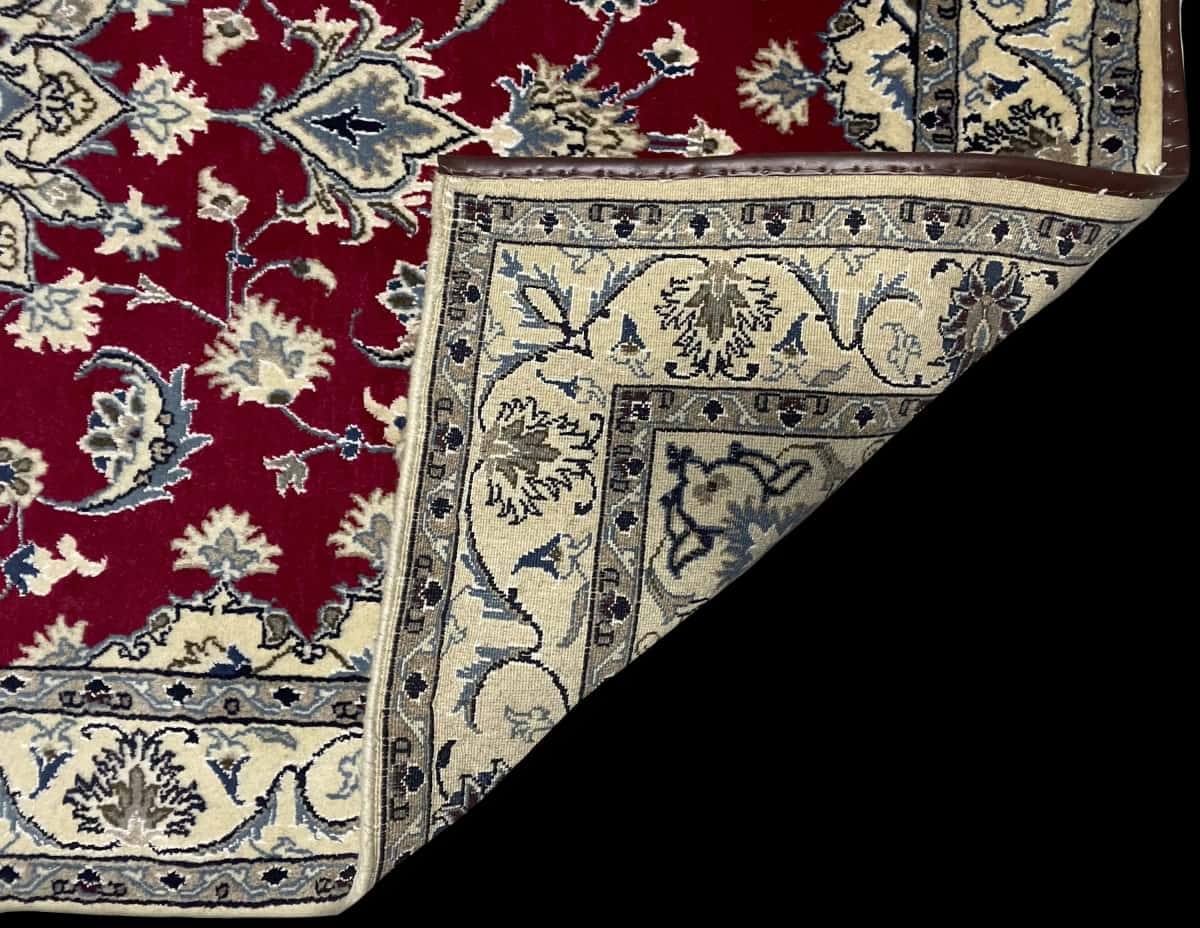 Persian rug of Nain style in dimensions 195 centimeters length by 115 centimeters width with mainly red colors — Folded
