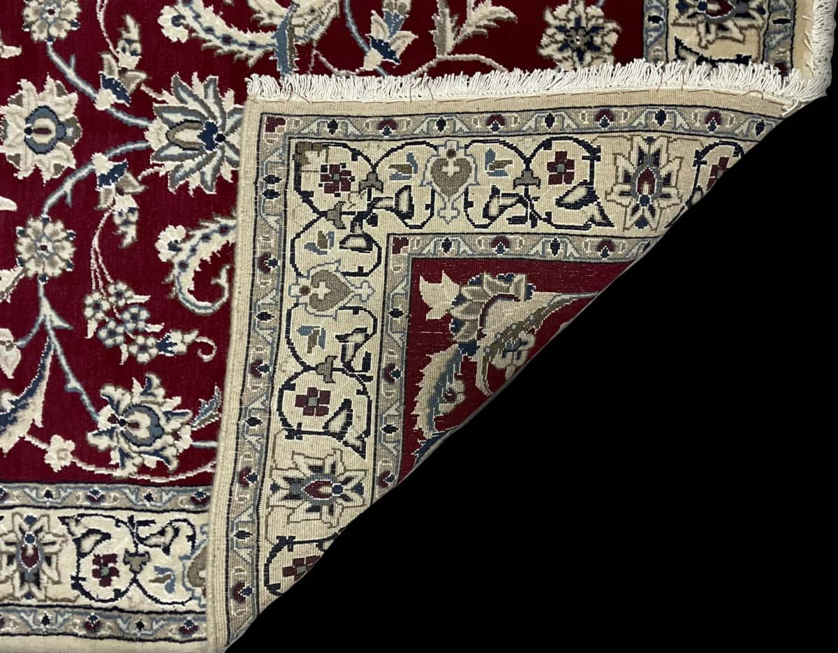 Persian rug of Nain style in dimensions 200 centimeters length by 118 centimeters width with mainly red colors — Folded
