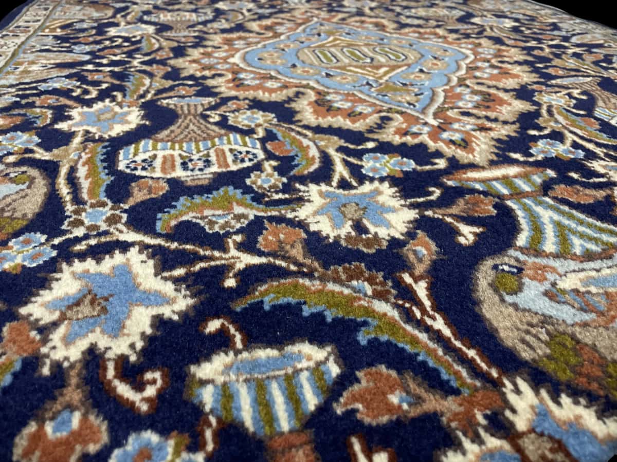 Persian rug of Kashmar style in dimensions 183 centimeters length by 107 centimeters width with mainly blue and black colors — Texture close-up