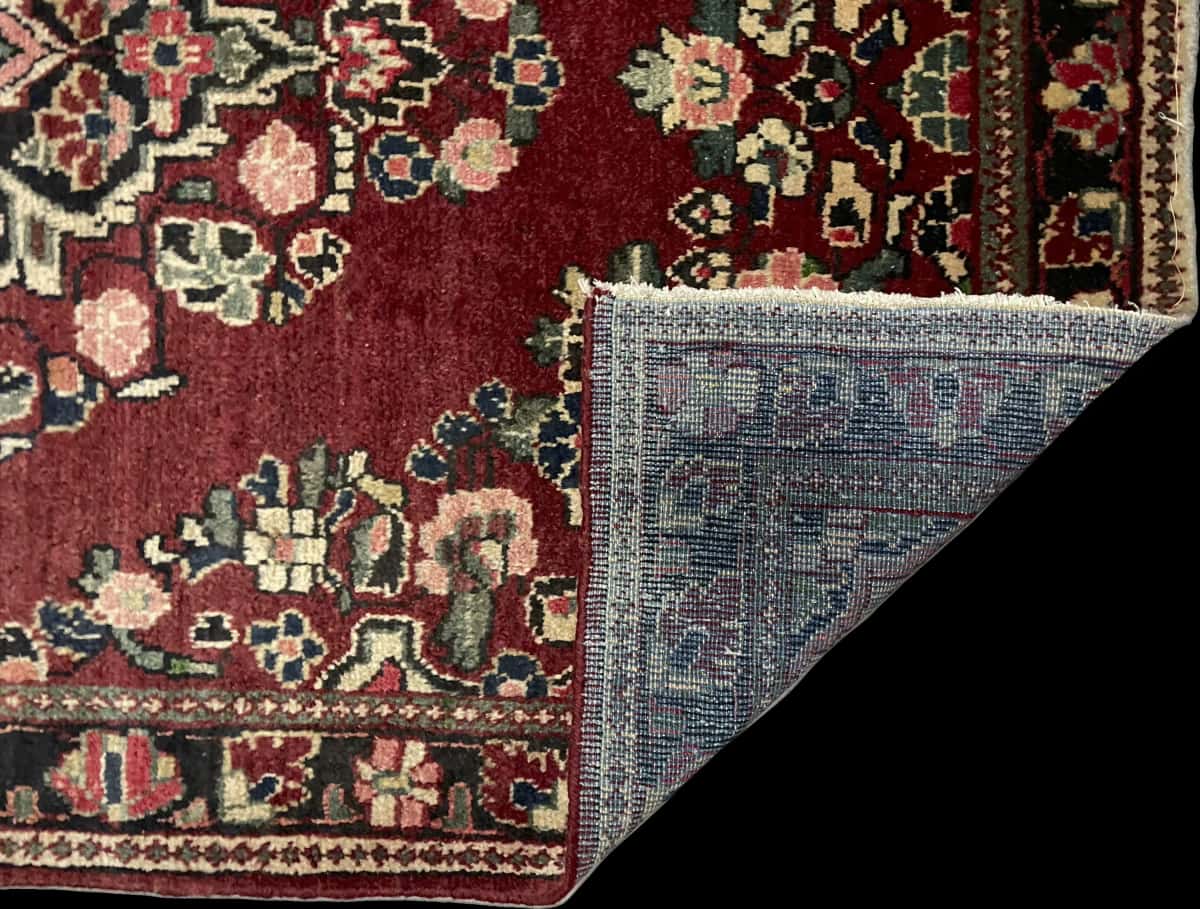 Persian rug of Arak style in dimensions 204 centimeters length by 126 centimeters width with mainly red colors — Folded