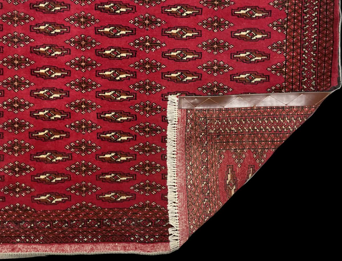 Persian rug of Turkoman style in dimensions 196 centimeters length by 132 centimeters width with mainly red colors — Folded