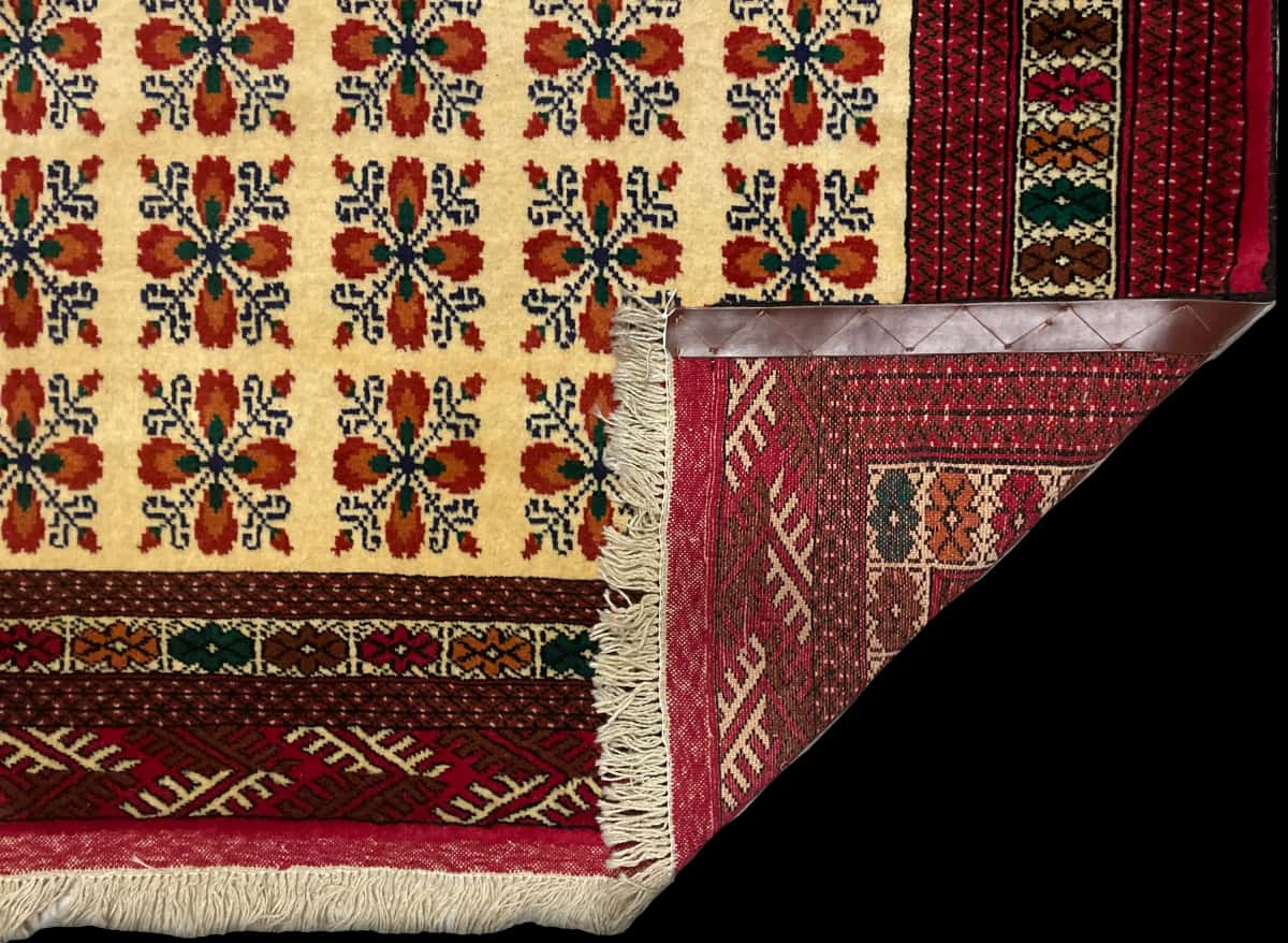 Persian rug of Turkoman style in dimensions 194 centimeters length by 132 centimeters width with mainly red and yellow colors — Folded