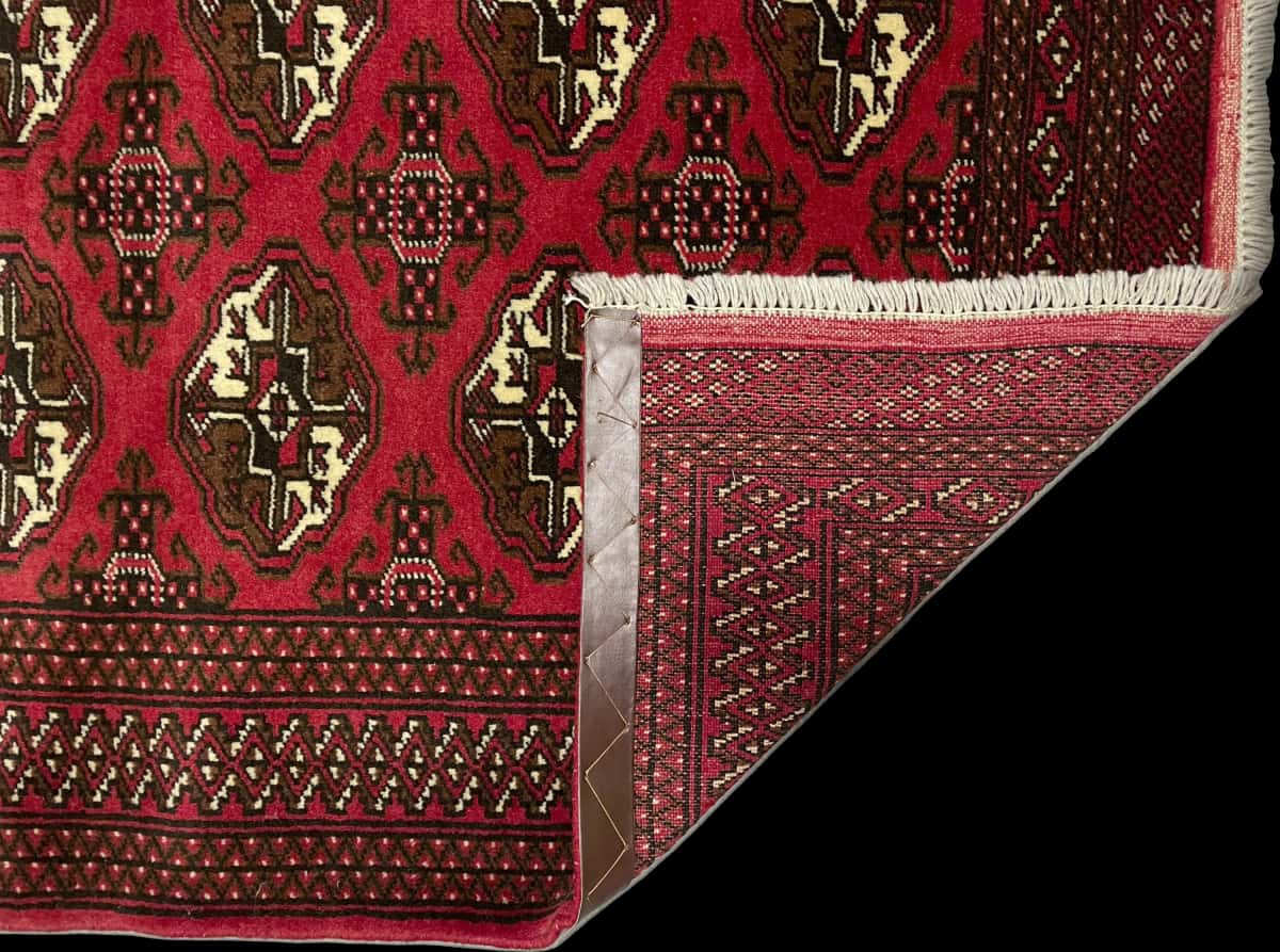 Persian rug of Turkoman style in dimensions 196 centimeters length by 135 centimeters width with mainly red colors — Folded