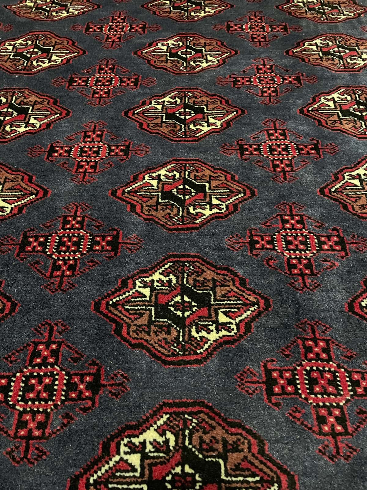 Persian rug of Turkoman style in dimensions 179 centimeters length by 130 centimeters width with mainly red and blue colors — Perspective