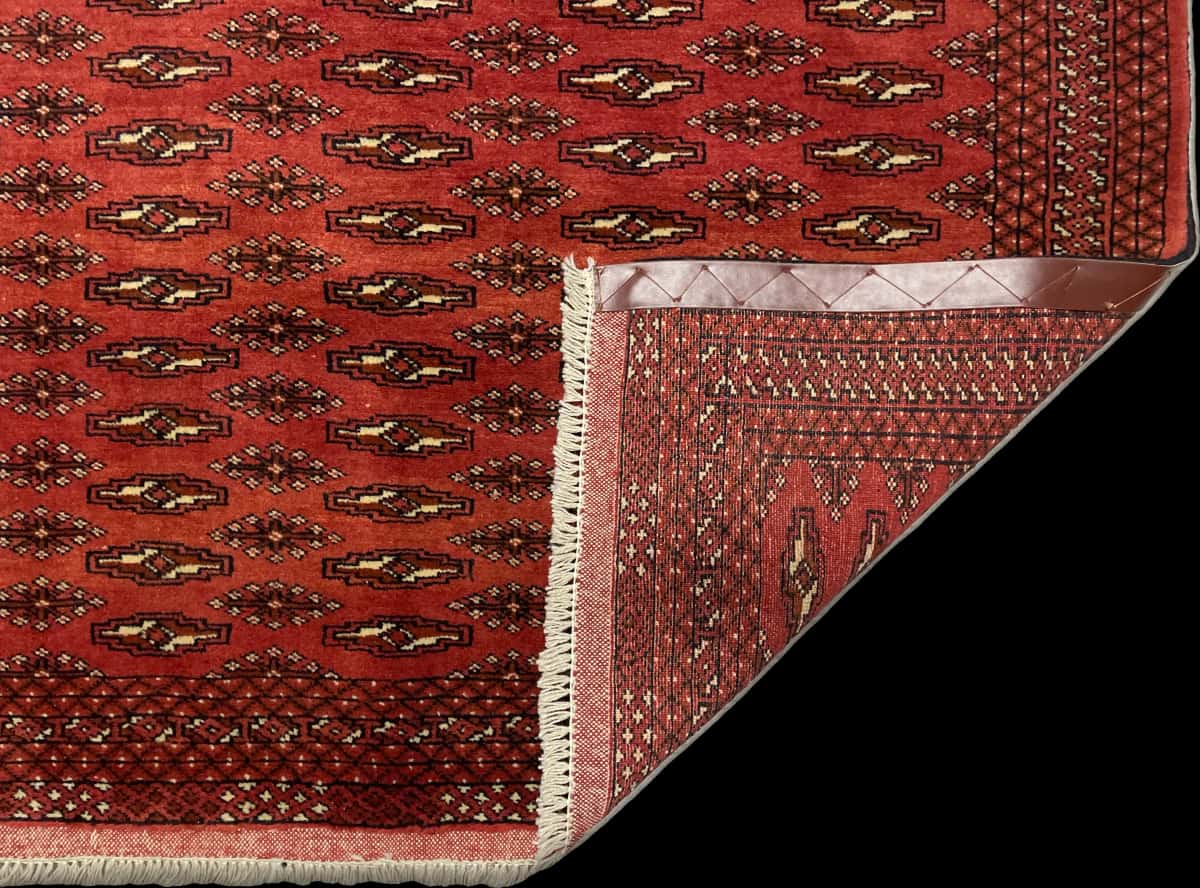 Persian rug of Turkoman style in dimensions 192 centimeters length by 125 centimeters width with mainly red colors — Folded