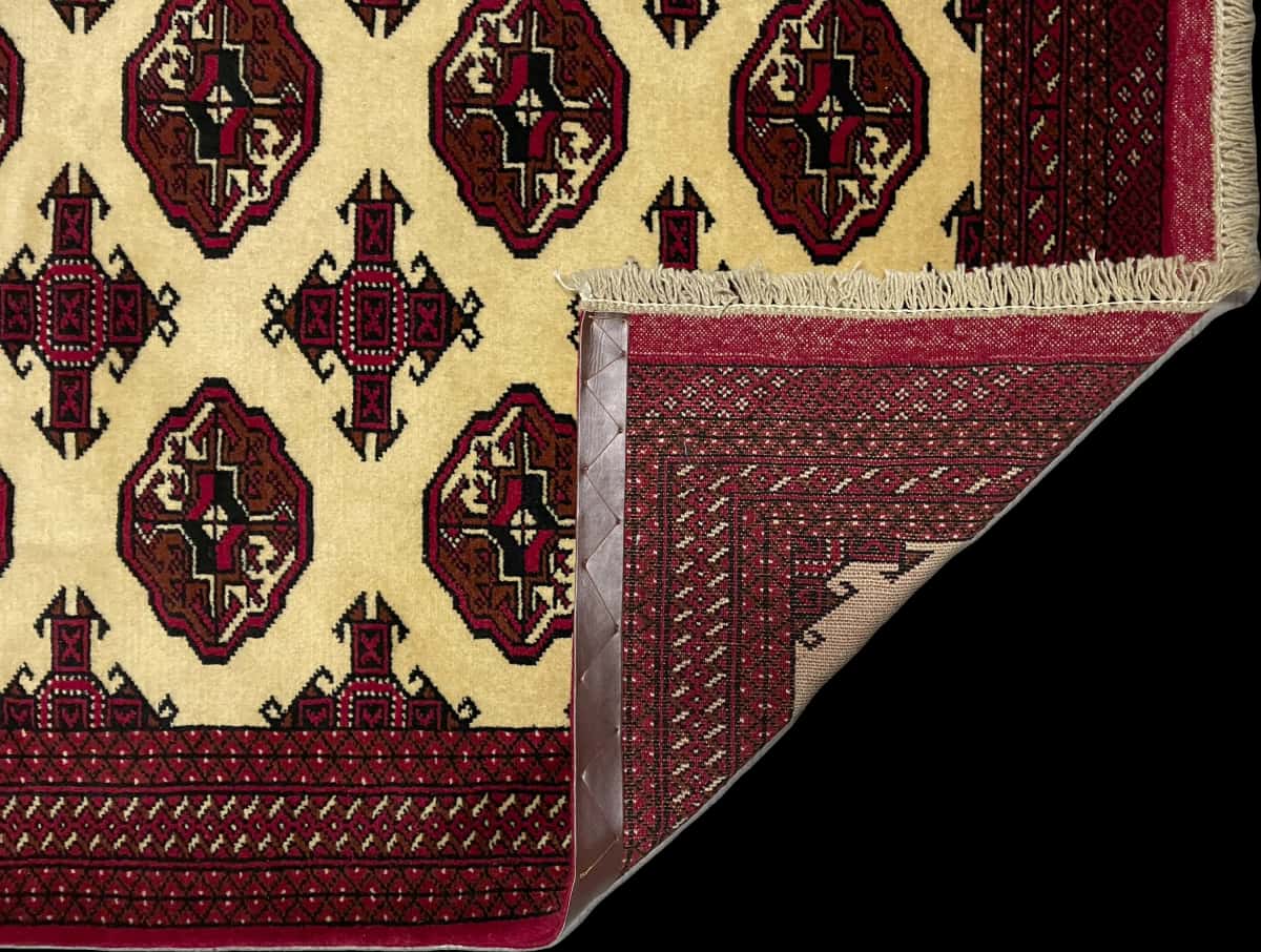 Persian rug of Turkoman style in dimensions 196 centimeters length by 136 centimeters width with mainly beige and red colors — Folded